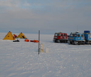 The base pole set in the ice and the camp set up