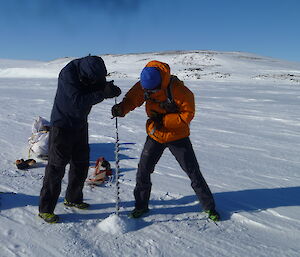 Craig and Stuart drilling the sea ice to measure the depth