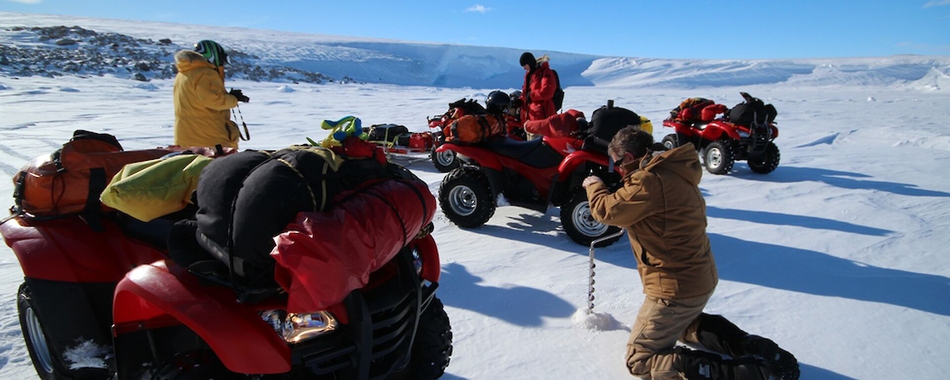 Drilling sea ice for quad travel