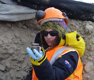 Danielle holding a frozen soil sample from the biopile