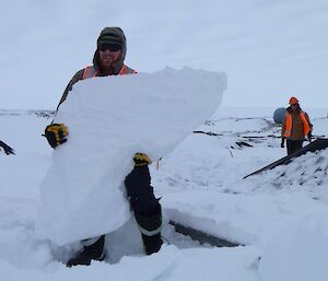 Dan with a large block of snow at the biopile site