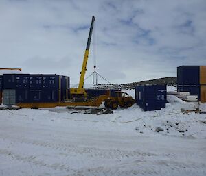 Getting another container from the stack down near the workshop for transport to the red shed and placement on the footings