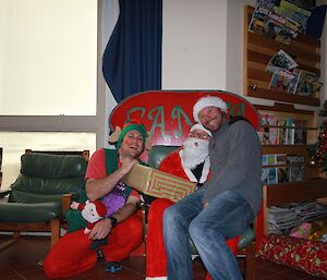 Mick receiving his present from Ben the elf whilst sitting on Santa’s knee