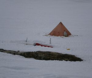 Nights accommodation of a bivie bag dug in for protection, whilst a polar tent in the background is used as a toilet tent