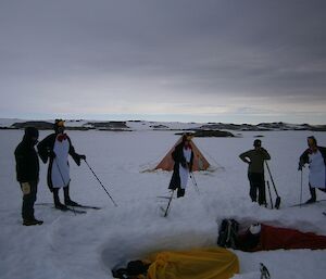 People dressed as penguins ski in for a visit to the group