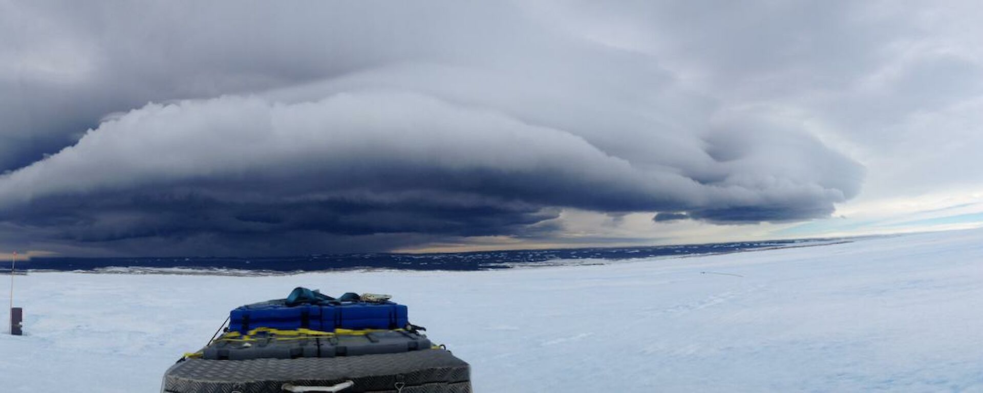 Cloud associated with strong winds in panorama over water
