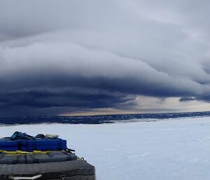 Cloud associated with strong winds in panorama over water