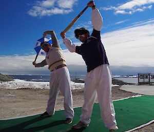 Two expeditioners stretching before a cricket match