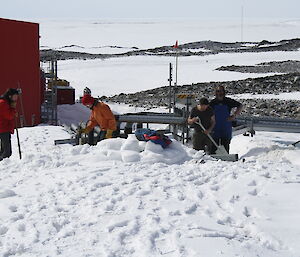 A number of French volunteers busy digging up snow