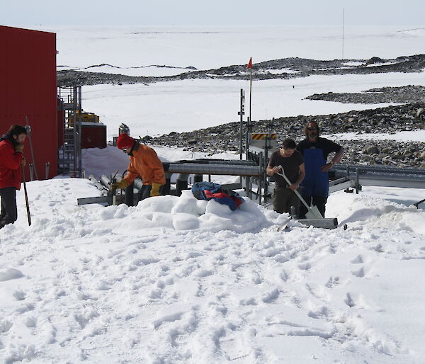 A number of French volunteers busy digging up snow