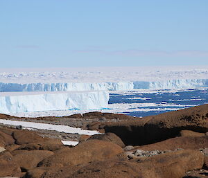 View of the edge of the glacier on top of a rocky hill