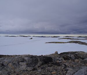 Landscape photo of snow and small rocky hills