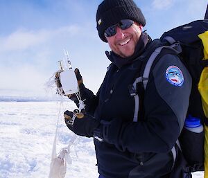 Glenn holds up balloon probe