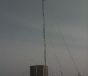 Receiver hut mast with a red arrow points to the web camera