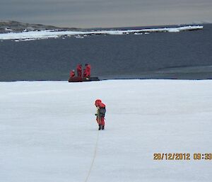 Gavin watches James walk on thin sea ice and attach a rope to the fuel line to transfer nearly 1 Million litres of diesel over water to Casey station