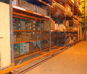 View of the warehouse stacked shelves and recently cleared empty spaces