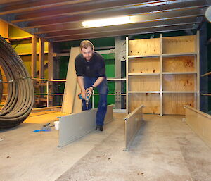 Expeditioner putting shelving back together on the mezzanine floor