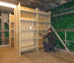 Expeditioner in a room full of warehouse equipment and shelving