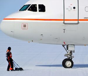 Aircraft ground support officer in front of the Airbus A319