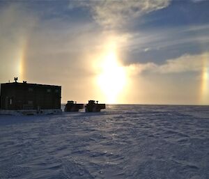 Buildings being towed with a Sun Dog in the background
