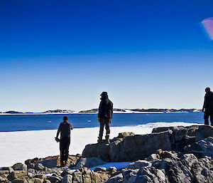 Three expeditioners staring at the view of Robbos