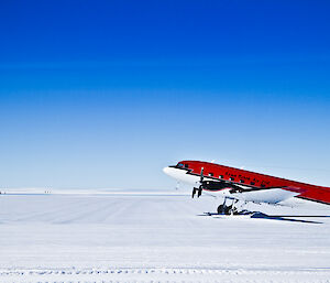 Basler BT-67 at Wilkins runway — a small plane on the ice, clear day