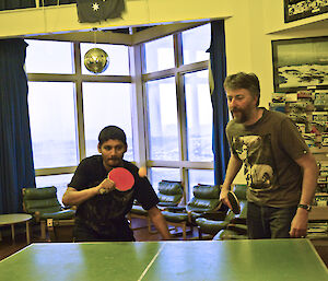 Abrar and Andy playing table tennis, Abrar about to hit the ball