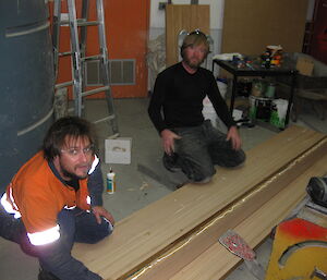 Ben and Tim on the floor with pieces of wood to make up a bench top