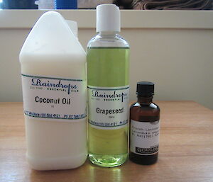 Three bottles of oil, coconut oil, grapeseed oil and French lavender oil