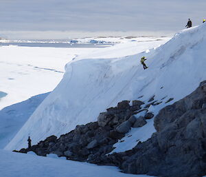 Steve descending the rope on search and rescue training, with a view of the frozen sea ice