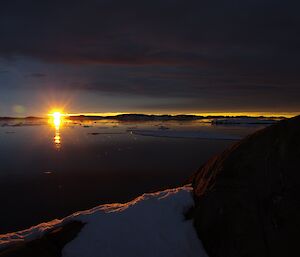 Sunrise shot over a still and reflective body of water