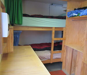 A small tight room with a bunk bed