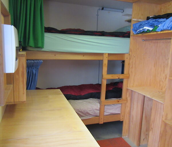 A small tight room with a bunk bed