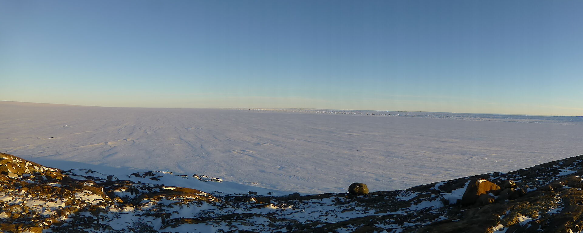 Landscape picture of the Vanderford Glacier with a rocky foreground