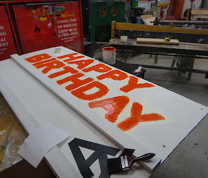 Painting the new sign bright orange