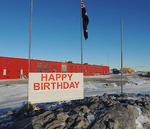 The new sign up in between the flag poles with Casey red shed in the background