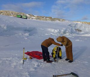 Drilling to test the depth of the sea ice