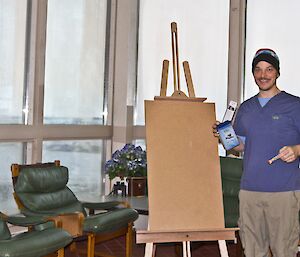Chad posing with a hand full of chocolates and sweets, easel and a book mark