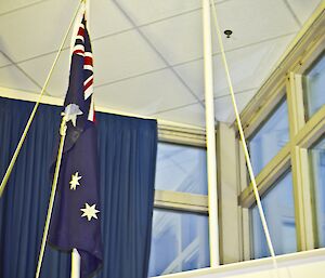 Australian flag hangs from a pole inside Casey station on ANZAC Day