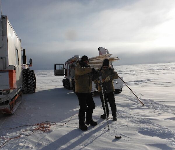 Mark and Gavin drilling ice to place new canes.