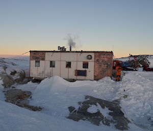 A picture of the Wilkes hut with snow all around