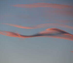 Lenticulas type clouds with sunset light reflections