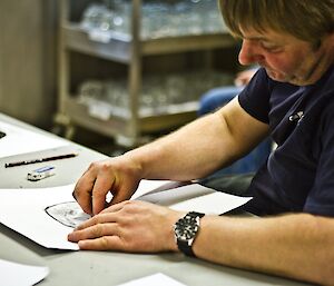 Jeremy at a table concentrating on his drawing