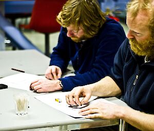 Matty and Timmy both sitting at the table drawing