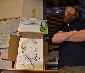 Matt standing next to his art work in a low camera angle shot