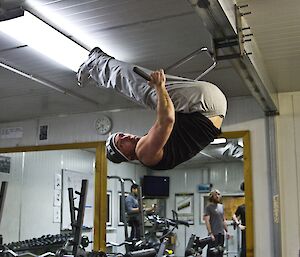 Lee hanging on the pull-up bars