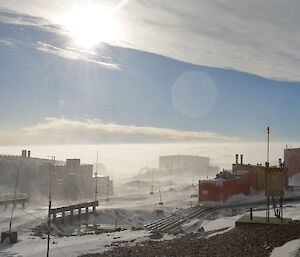 Picture of blowing snow in Casey. Building have a slight white haze around them