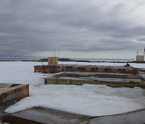 Nearly fully cover old station buildings, only parts of the roofs exposed