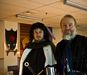 Aaron and Jukka dressed as characters, decorated shields and candle lit room