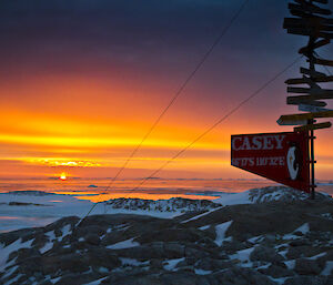 Strong gold, orange and red sunset, with the Casey sign in the foreground